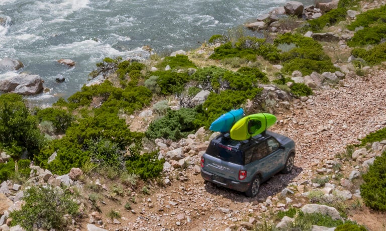 2025 Ford Bronco driving with kayaks on top