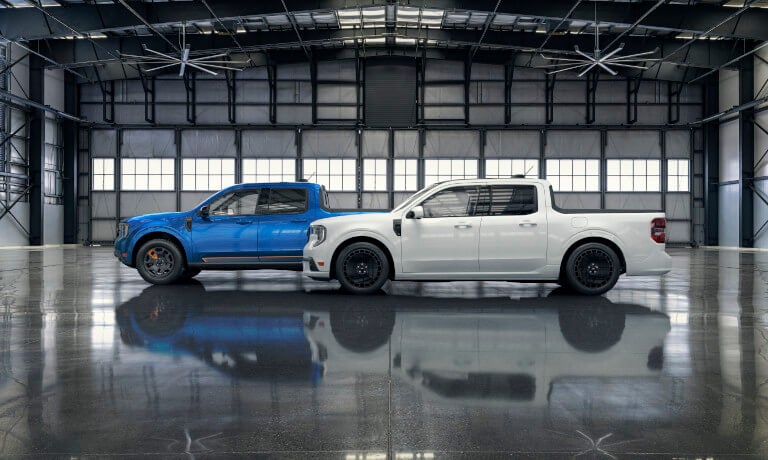 Two 2025 Ford Maverick trucks parked in warehouse